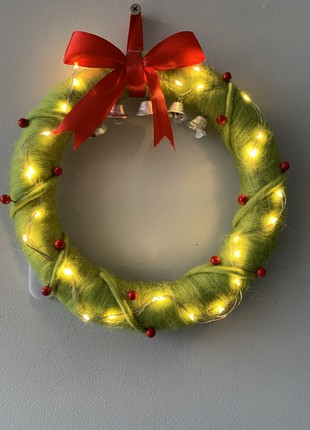 Wreath on the door with lighting decoration for the new year and Christmas