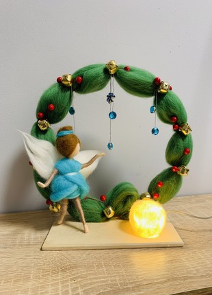 A stylish New Year's nightlight for a girl, an original Christmas gift, a table lamp with a baby angel, a winter composition
