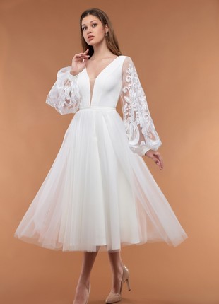 A white dress with an elegant airy sleeve and a lush skirt1 photo
