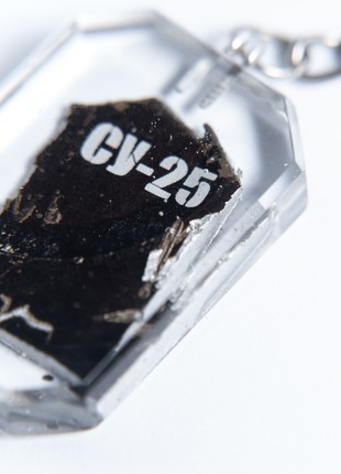 A keychain with a piece of taken down russian su-25 aircraft