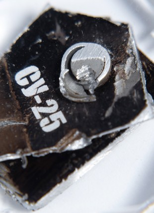 A keychain with a piece of taken down russian su-25 aircraft1 photo