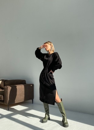 The dress with slits on the sides and a drawstring at the waist is black