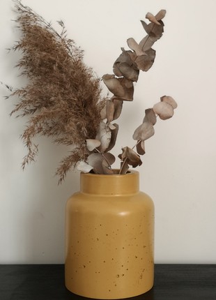 Yellow concrete vase for flowers