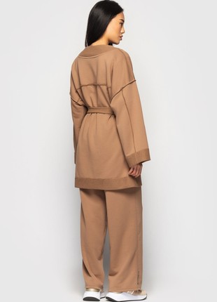 The suit with a cardigan and loose trousers is light brown6 photo