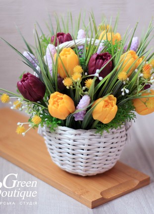 A cute interior bouquet of soap tulips in a wicker basket