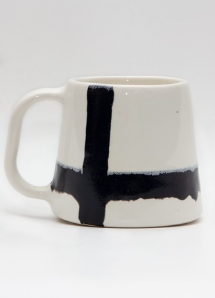 Handmade white ceramic mug with black stripes