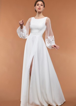 White floor-length dress with long sleeves and a slit