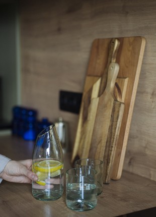 A set of a transparent glass jar and two glasses made of recycled glass