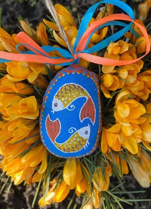 Little blue Easter egg with fishes.