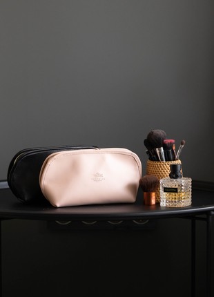 Leather cosmetic bag in powder color.