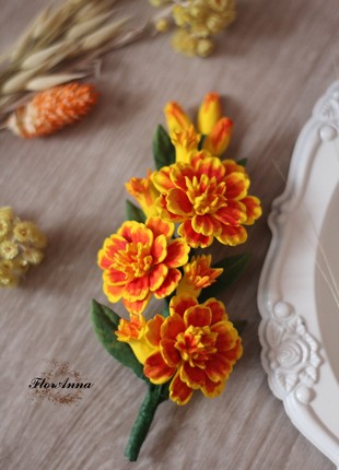 A large brooch with marigolds