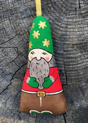 Handmade toy dwarf in a green hat with stars