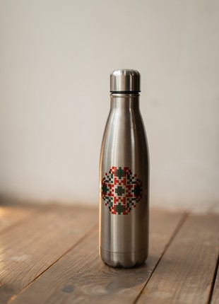 Metal thermos in bottle format with coded ornament
