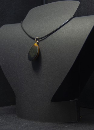 The pendant is orange-black. Drop2 photo