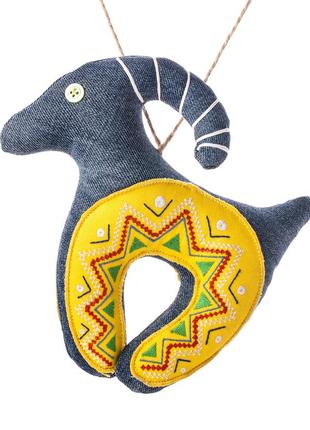 Denim goat with a yellow embroidered horseshoe