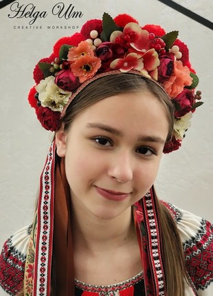 A wreath of pom-poms, artificial flowers and berries