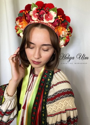 A wreath of pom-poms, artificial flowers and berries