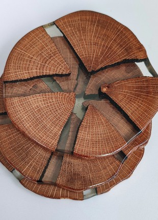 Set of six round wooden coasters with transparent epoxy resin