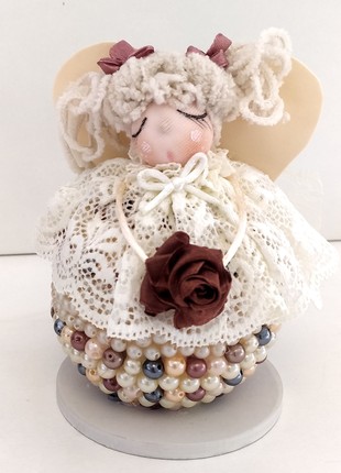Doll on a layer of pearls