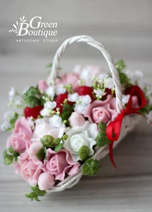 Luxurious interior bouquet of soap roses and strawberries in a wicker basket