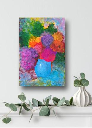 Painting with a bright bouquet of flowers in a blue vase