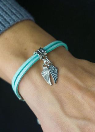 Suede bracelet - amulet with pendant "wings"1 photo