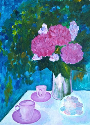 Classical still life with flowers in a vase and cups with tea on the table and sweet biscuits in the summer garden
